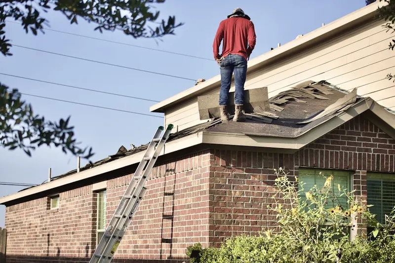 Professional roofer working on a residential roof in Sherman Corner
